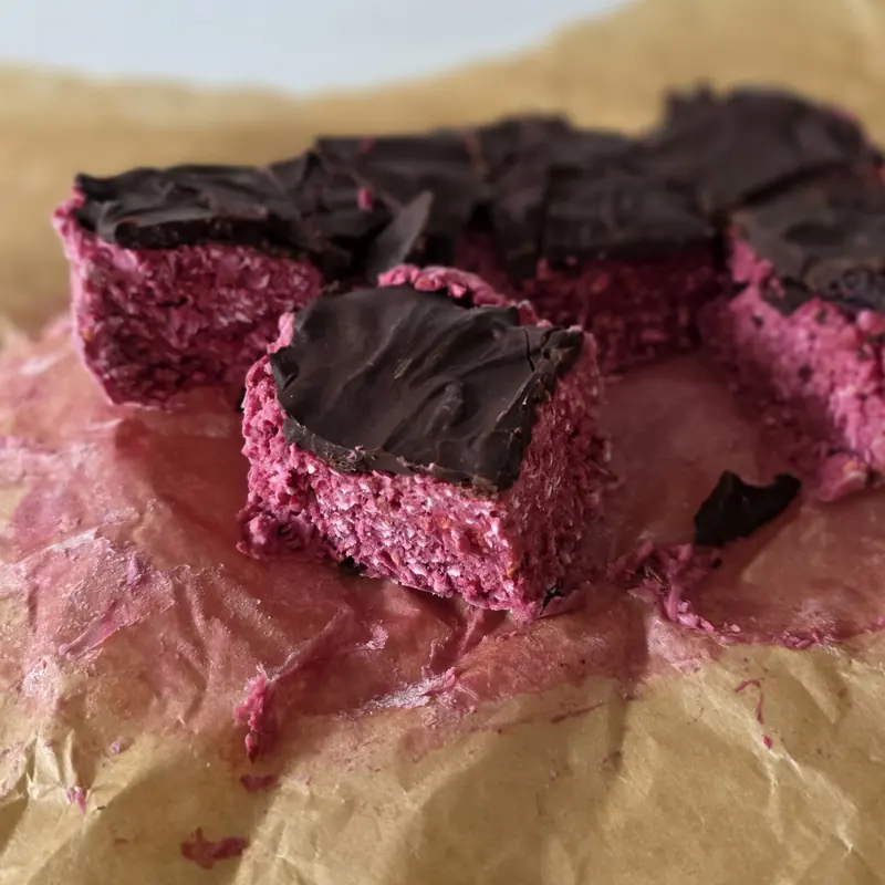 Homemade dark chocolate raspberry ruffle bars, sliced and coated in dark chocolate